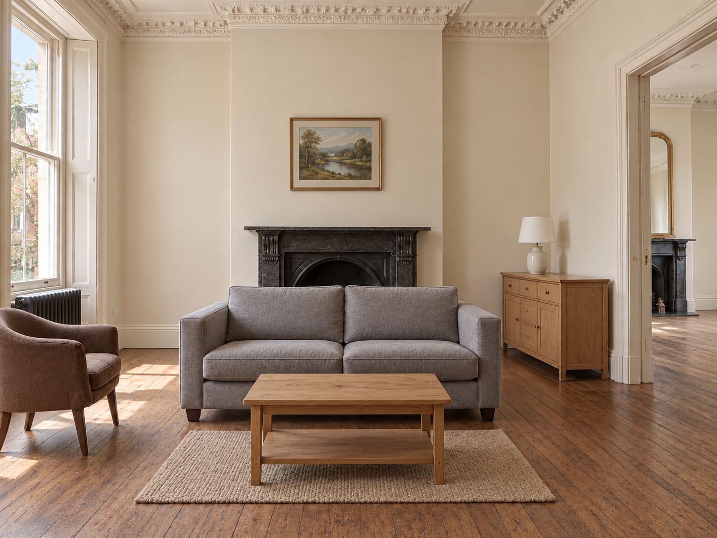 Beige walls, a small grey sofa, undersized print and a lonely coffee table leave a grand reception feeling rented.