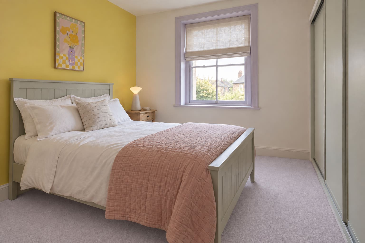 Compact bedroom with a citron wall, dove-grey double bed, white linen and a single bobbin bedside table.