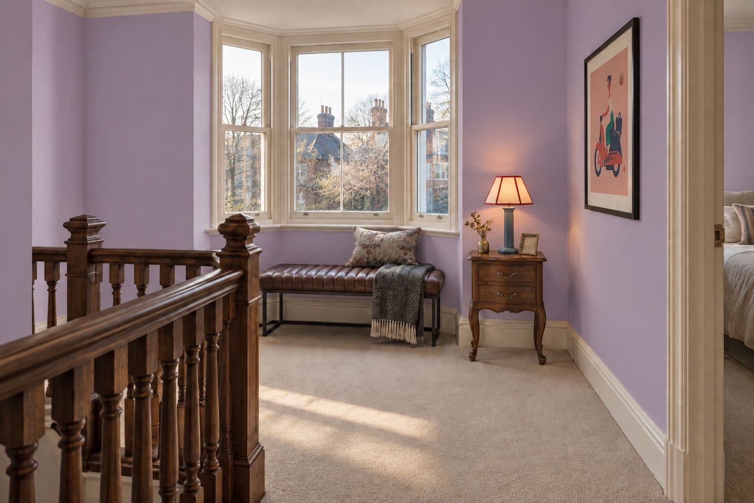 Wisteria Edwardian landing with a brown upholstered bench, small table and framed graphic artwork clear of the stairs.